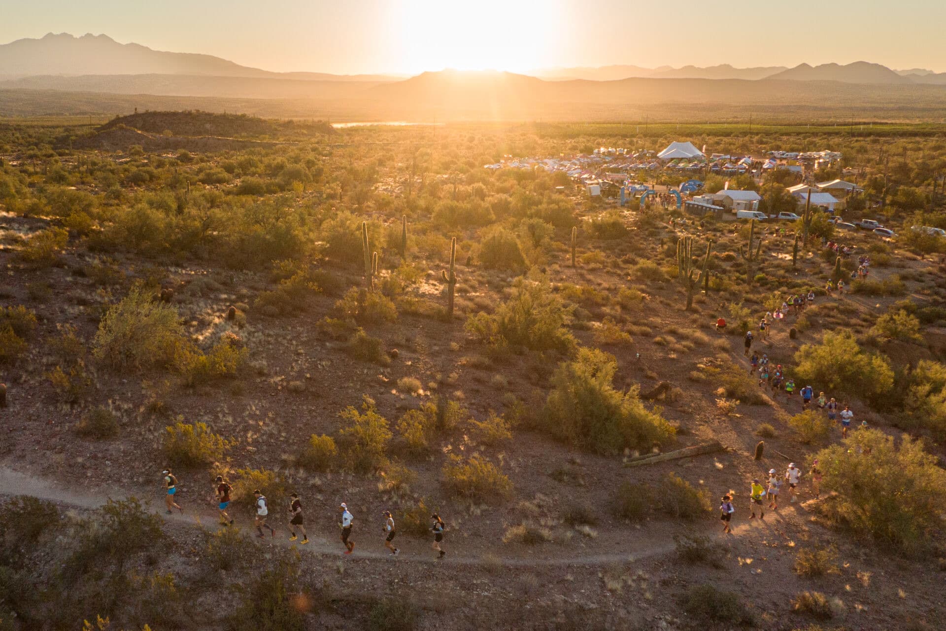 Aerial view of runners crossing the desert at sunrise during Javelina Jundred